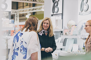 Stall holder discussing a product with a customer