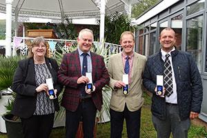 Four staff members from Wyevale Nurseries with their 120 years of service awards